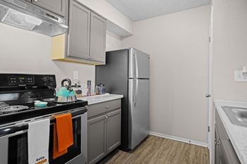 Kitchen with stainless steel appliances and a refrigerator
